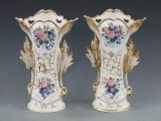A pair of French porcelain vases with leaf handles, decorated with flowers, 34cm tall
