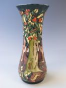 Moorcroft pedestal trumpet vase decorated with trees and berries, dated 99 to base, 31cm tall