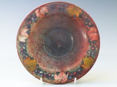 William Moorcroft flambé teapot stand in Leaf and Berry pattern, signed to base, diameter 19.5cm