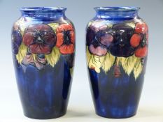 William Moorcroft pair of large baluster vases in Pansy pattern on a navy blue ground, one with full