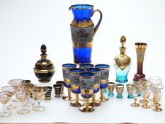 Six Venetian style coloured and gilt glass drinking sets, one with enamelled decoration of a hunting