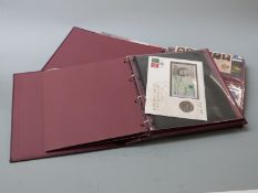Two albums of GB coin/stamp covers