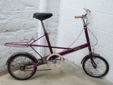 Purple Moulton midi unisex bicycle with three gears, carrier and original rubber suspension