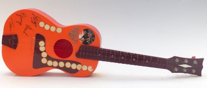 Beatles Big 6 toy acoustic guitar, orange plastic body with faux autographs, fitted with nylon