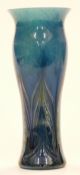 Loetz Papillon style glass vase with feathered decoration over mottled blue ground, 21.5cm tall.