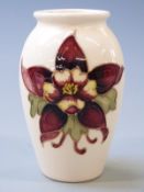 Moorcroft vase decorated with freesias on a cream ground, 10.5cm tall