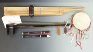 A collection of various instruments to include an Asian Erhu, Oriental bamboo pipes, descant