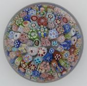 Baccarat close pack millefiori glass paperweight with various multi-coloured canes including one