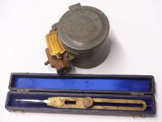 A cased set of military brass dividers and a Horstmann engineering gas lamp or similar timer
