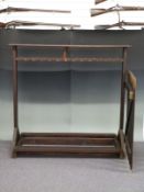 A double sided gun rack or display stand with attached gate, L218cm x D70 x H137cm