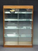 Oak glazed shop fitting or haberdashery display cabinet with sliding doors, adjustable glass shelves