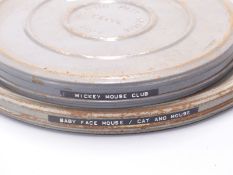 Two vintage 16mm cartoon film reels, one marked 'Mickey Mouse Club' and the other 'Baby Face Mouse/