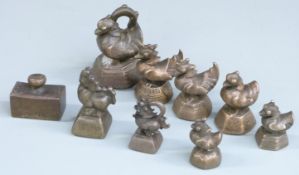 Nine opium and similar weights including birds on hexagonal and octagonal bases, dogs on square