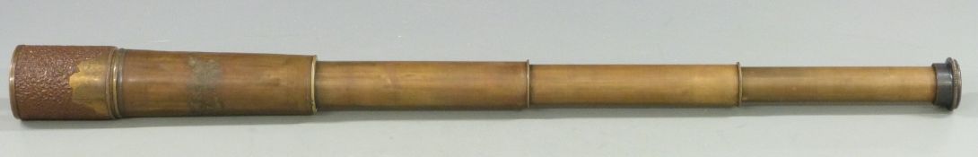 A brass four draw telescope with broad arrow mark and further markings