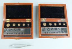Two George V cased sets of County of Monmouth standard weights 100 grain downwards, larger weights