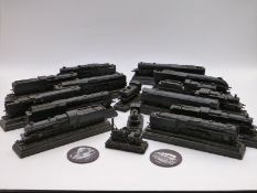 Approximately sixteen 00 gauge model locomotives each carved from a block of coal