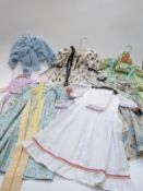 Seven childrens or large dolls' dresses and outfits most with floral patterns
