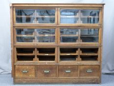 Haberdashery shop fitting oak drawer unit having six banks of four drawers behind up and over glazed
