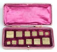 Leather cased 19thC or early 20thC set of apothecary weights from 120 grains downwards