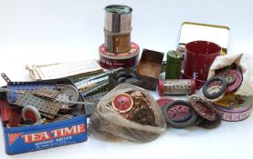A large collection of loose Meccano pieces together with various sheets of instructions