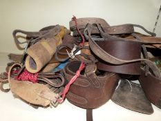 A large collection of equestrian items including riding hats, one Charles Owen size 7 3/8, leather