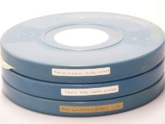Three vintage Laurel & Hardy 16mm cine film reels marked 'The Hoose Cow', 'Launching Gravy' and '