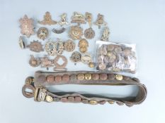 A small collection of military cap badges and buttons to include Gordon Highlanders, Black Watch,