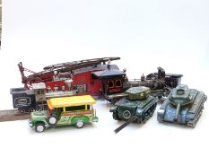 Six tinplate model vehicles comprising two tanks, a fire engine, two trains and a Philippine