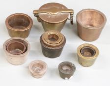 A quantity of various nesting cup weights including an outer case, largest weight 8oz