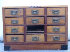 Meccano branded wooden cabinet with 12 drawers each with campaign style handles, 72x51x41cm.