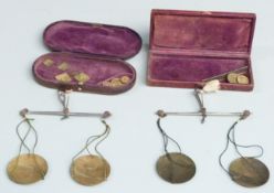 Two W & T Avery cased sets of travelling beam scales, one with sovereign weights, the other