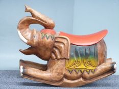 A carved and painted wooden rocking horse in the form of an elephant, 66cm long