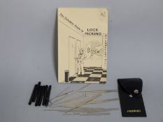 A lock picking set with a Complete Guide to Lock Picking