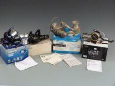 Four fixed spool reels comprising three Shakespeare examples Salt Surf reel, Cypres XT 60, Contender