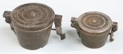 Two cased runs of bronze nesting cup weights, height of larger 3.5cm