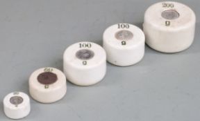 A run of cylindrical ceramic weights 200g to 20g
