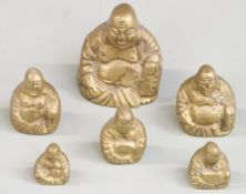 A run of six brass weights formed as Buddhas