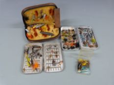 A collection of fly fishing flies and a Wheatley fly box with salmon and sea trout flies