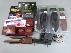 A collection of shotgun/ rifle parts and accessories including butt pads, snapcaps, scope eyepiece