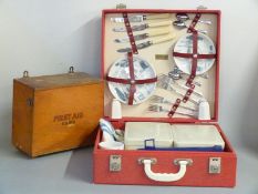 Brexton England picnic set in red rexine case, 1950's, together with a wooden first aid box