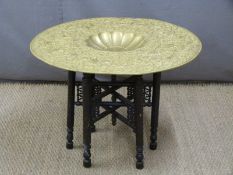 Thai/Burmese or similar gilt metal-topped table with embossed top, D77cm