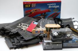 A collection of Scalextric model slot car racing cars, track, buildings and accessories, some in