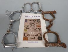 Three pairs of vintage handcuffs, book etc