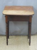 A 19thC mahogany two drawer side or bedside table or cabinet raised on turned legs, L51 x H66cm