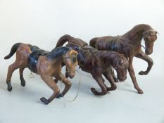 Three leather covered horses in the style of Liberty, length 35cm