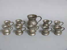 A quantity of pewter measures or tankards