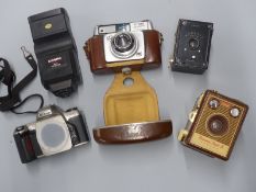Four cameras comprising Nikon F65 SLR, Kodak Hawkeye 127, Brownie Flash B, Ilford Sportsman and