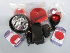 A collection of gun light parts, accessories and lenses, some new in original packaging
