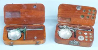 Two wooden cased sets of diamond or similar travelling scales. Width of larger case 12cm