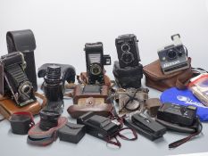 Collection of vintage cameras including Lubitel 166B TLR, Seikosha , Poloroid, Zeiss Ikon Nettar